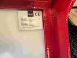 a close up of a red door with a sign on it