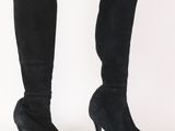 black sued high heel boots on a white background