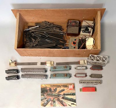 a box of toy train tracks and a box of other toy trains