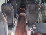 many seats in the back of a bus that are empty