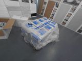 boxes of toilet paper are stacked on top of a cart in a room