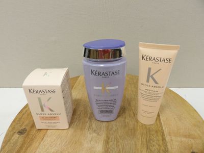 a bottle of kerastase next to a box of cream and a tube of lotion
