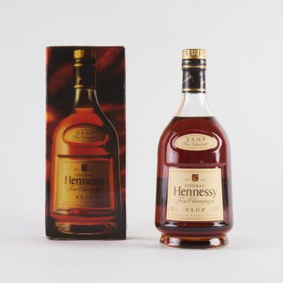 the bottle of hennesso is next to the box