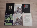 three books on a wooden floor with a picture of a woman