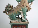 a statue of a lion that is sitting on a table