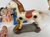 a small group of toy figurines of a horse and people