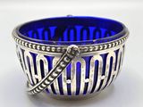 silver and blue glass bowl with a spoon in the middle