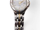 an image of a close up of a wrist watch on a white surface