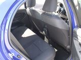 a blue car with the door open and the seats down