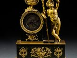 a statue of a woman holding a clock on top of a table