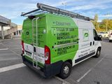 a green and white van parked in a parking lot