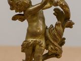 a statue of a boy holding a bird on a table