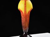a vase that is sitting on a table with a black background
