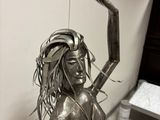 a statue of a woman holding a knife in her hand