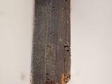 a person holding a piece of wood in their hand