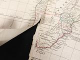 a piece of paper with a map on it next to a pair of scissors