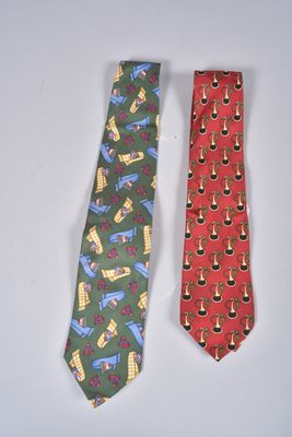 pair of neck ties with different designs on them on a white surface