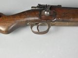 an old rifle with a wooden barrel and a wooden handle