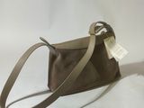 a brown purse with a strap and a tag on it