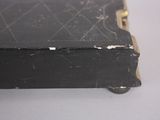 a black box with a gold handle sitting on a table