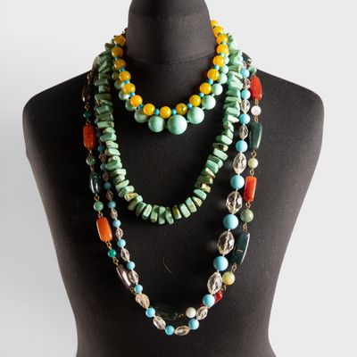 a close up of a mannequin wearing a multi colored necklace