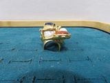 a gold ring with a red, white, and blue stone on it
