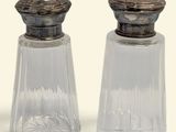 two salt and pepper shakers sitting next to each other