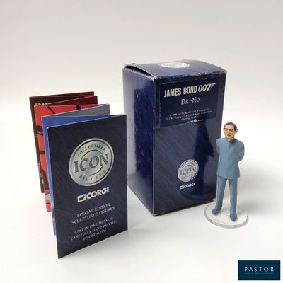 a figurine of a man standing next to a box of books