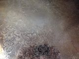 a large silver plate with intricate designs on it