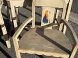 two wooden chairs and a desk in the middle of the street