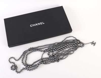 chanel necklace in black box with chain on white background