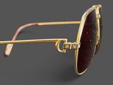 a close up of a pair of sunglasses on a gray surface