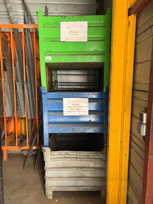 a stack of crates in a warehouse with a sign on it