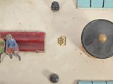 some figurines are sitting on top of a table next to a clock