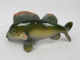 a small fish figurine sitting on a white surface
