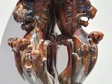 a vase that has two lions on top of it