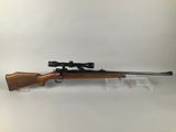a rifle with a scope mounted on the side of it