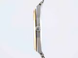 a close up of a watch on a metal pole