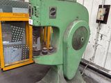 a green machine that is sitting in a warehouse