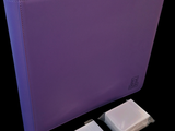 a purple binder with two small pieces of tape on it