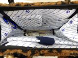 a purse that has a stuffed animal inside of it
