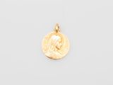 a gold coin with a woman ' s face on it