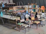 many chairs and tables in a room with a ceiling
