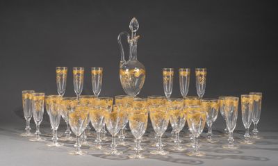 many wine glasses and a decanter on the table