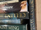 many books stacked on top of each other in a box