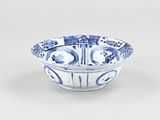 blue and white bowl with a design of flowers and birds