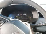 steering wheel of a car with a digital display on the dashboard