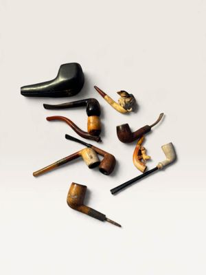 many different types of smoking pipes on a white surface