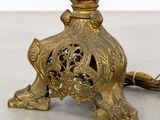 a gold lamp that is sitting on a table