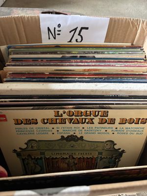 a lot of records in a box with a price tag
